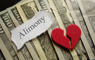 Broken red heart and Amimony paper note on cash